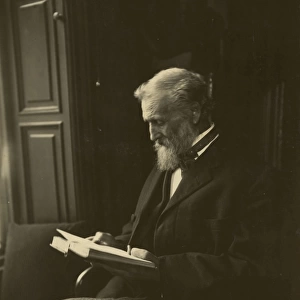 John Muir, seated, reading a book