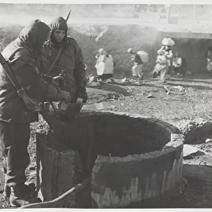 Korean War - two soldiers at well