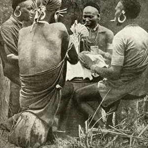 Four men playing cards, Kenya, East Africa