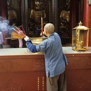 Monk and incense, Temple of the Six Banyan Trees