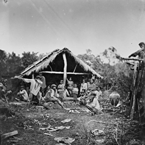 Natives grouped in front of a hut, Manila, Luzon, Philippine