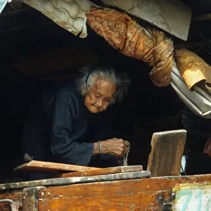 An old woman on a junk in a typhoon shelter, Hong Kong