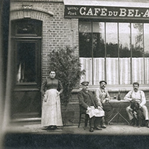 Six people and a dog outside a cafe, France
