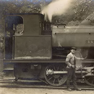 Railway workers pose with steam engine