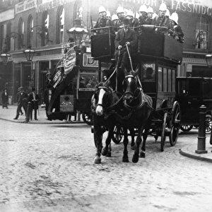 Soldiers riding on the top deck of a London omnibus