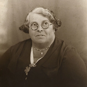 Studio portrait, middle-aged woman in glasses
