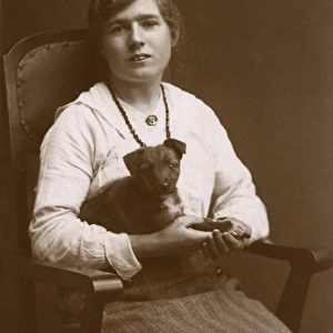 Studio portrait, woman with puppy