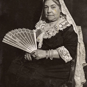 Woman in costume posing as Queen Victoria