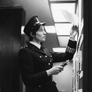 Woman police officer at work in a London police station