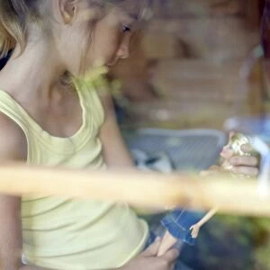 Girl playing in a Wendy house