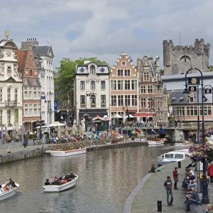 Everyday scene along the Graslei bank, lined with Baroque style Flemish gabled houses, Gravensteen Castle beyond, in the centre of Ghent, Belgium, Europe