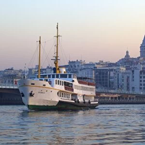 Ferry boat in Golden Horn with Galata Tower in background, Istanbul, Turkey, Europe