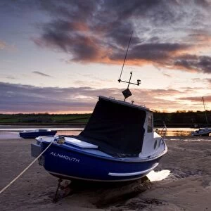 Fishing boat on the Aln Estuary at sunset, Alnmouth, near Alnwick, Northumberland