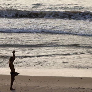 Man doing yoga on Jaffa beach, Jaffa, Israel, Middle East