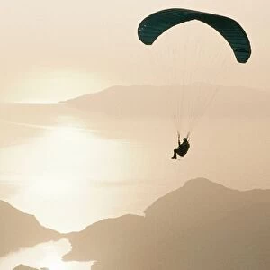 Man paragliding over the Mediterranean coast
