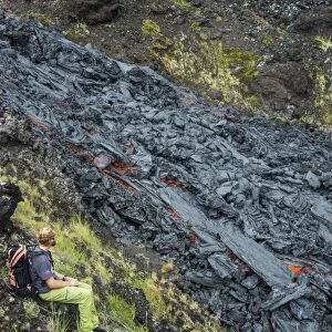 Man watching an active lava stream, Tolbachik volcano, Kamchatka, Russia, Eurasia