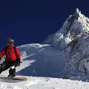 A snowboarder riding powder snow off the top of the famous Grand Montets ski area