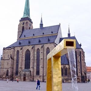 St. Bartholomews Cathedral and one of the three modern gold fountains, Republic Square