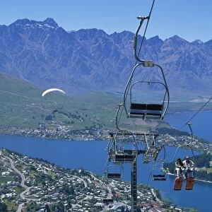 Tourists on a chair lift with Lake Wakatipu