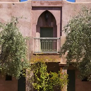 Typical Moroccan architecture, riad adobe walls, fountain and flower pots, Morocco