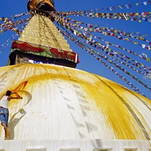 Young man throwing saffron water on the stupa in order