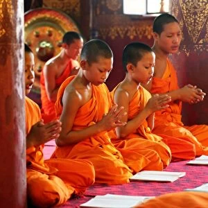 Buddhist monks at worship in Wat Sen temple in Luang Prabang, Laos