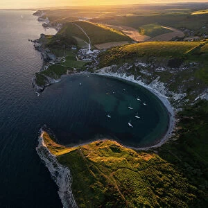 Aerial view of Lulworth Cove at sunset with boats, Durdle Door, Dorset, United Kingdom