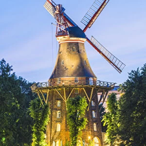 Bremen, Bremen State, Germany. The MAohle am Wall windmill illuminated at dusk