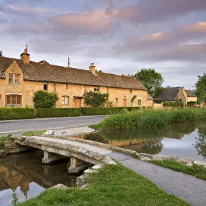 Cottages and stone footbridge in the Cotswolds village of Lower Slaughter, Gloucestershire