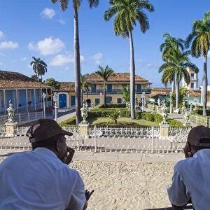 Cuba, Trinidad, Two Security guards look across Plaza Mayor