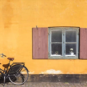 Denmark, Zealand, Copenhagen, yellow building detail with bicycle