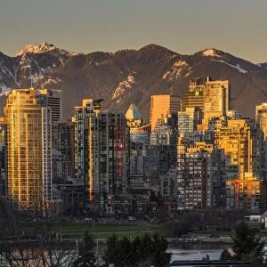 Downtown skyline with snowy mountains behind at sunset, Vancouver, British Columbia