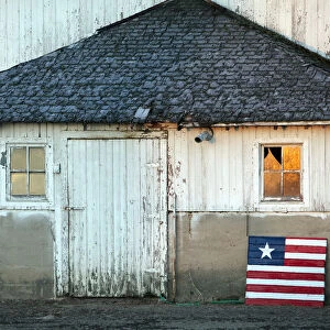 Idaho, USA. An american flag in front of a barn