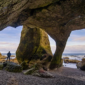 Man in Cathedral Cave, Co. Antrim, Northern Ireland