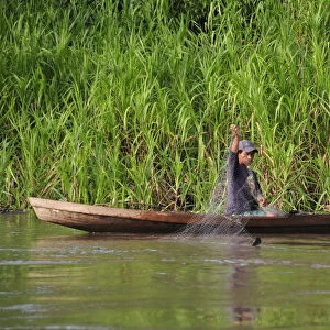 Man fishing on the Amazon River, near Puerto Narino, Colombia