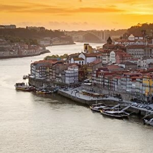 Portugal, Douro Litoral, Porto. Sunset over the UNESCO listed Ribeira district, viewed