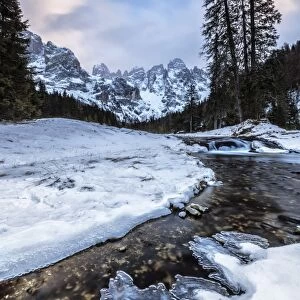 Sunset on a frozen creek. Venagia Valley Panaveggio Natural Park Dolomites Trentino