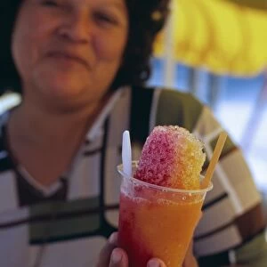 A vendor serves up a shaved ice treat on the beach at Mancora