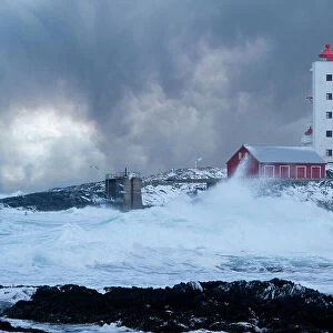 Waves spray in the cold Barents Sea, near Kjolnes lighthouse, breaking on rocks, Sandfjorden, Arctic Ocean, Varanger Peninsula, Troms og Finnmark, Norway