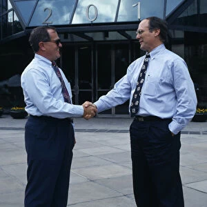 USA, Florida, Orlando Two businessmen in conversation shaking hands outside modern
