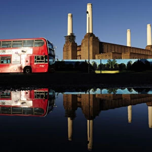 Battersea Power Station is seen reflected in water in west London