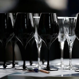 Black glasses specially designed for wine blind testing are seen on a table during the