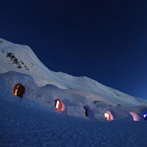 Dimmed lights are switched on in igloos on top of the mountain Nebelhorn near Oberstdorf