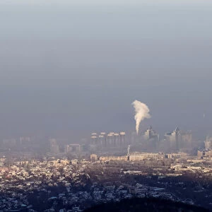 A power station is seen through smog covering Almaty