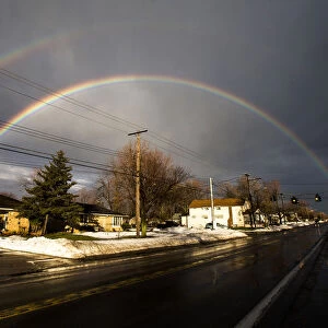 A rainbow forms over a neighbourhood following a massive snow storm in West Seneca