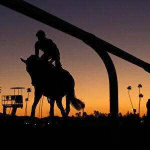 Riders take part in workout at dawn for the Breeders Cup horse race at Santa Anita
