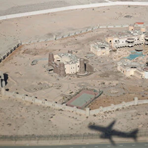 Shadow of Etihad Airways plane is seen at old buildings near Abu Dhabi International