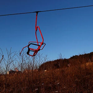 A ski lift chair hangs at the abandoned Alps Ski Resort located near the demilitarized