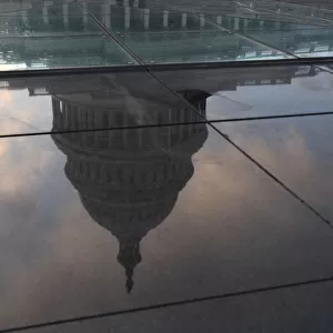 The U. S. Capitol building is seen in a reflection on Capitol Hill in Washington