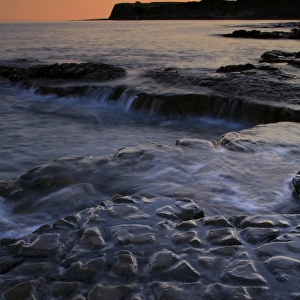 View of rocky beach at sunset, Hobarrow Bay, Isle of Purbeck, Dorset, England, july